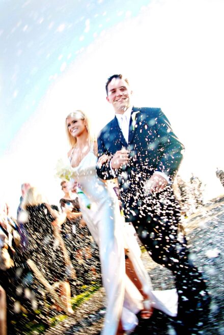 bride and groom walking down aisle with confetti being thrown