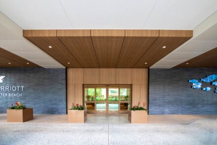 entrance of jw marriott clearwater with wood grained aluminum roof and wall panels and blue tiled wall