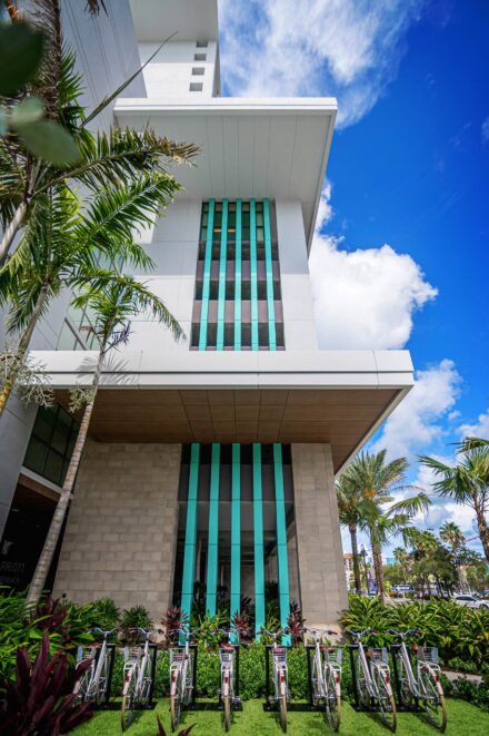 decorative green aluminum slat panels with bicycles in front