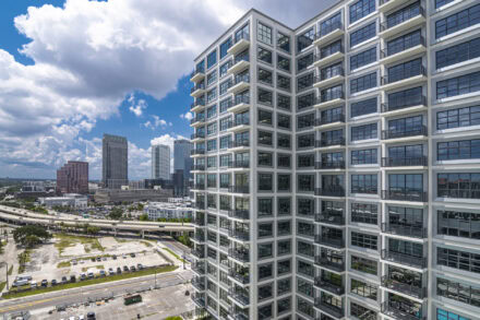 Asher Residential Apartment Condominiums on water street tampa with backdrop of high rise buildings and highway