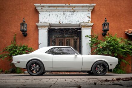 1972 restored chevy camaro in front of white column facade terra cotta colored building
