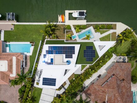 overhead drone image of unique architectural Bird Key home with solar panels on Sarasota Bay