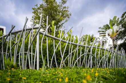 nature inspired grass shaped aluminum railing with grass and sky backdrop