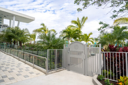 gate with aluminum and glass railing and lush tropical landscaping