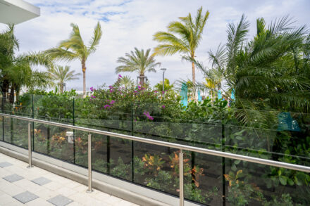 Aluminum and Glass Railing on a walkway like with lush tropical landscaping