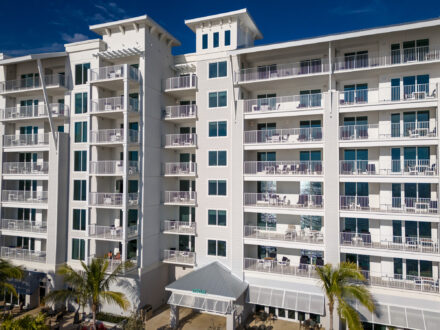 aerial view of a large multilevel hotel with aluminum balcony railing