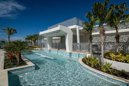wading pool with waterfall, tropical landscaping and decorative aluminum railing