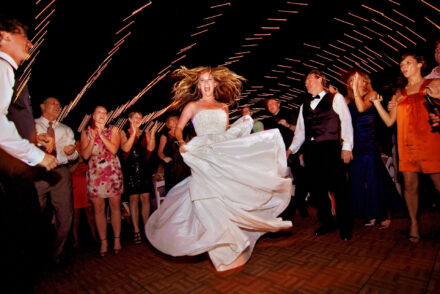 bride twirling and dancing with guests surrounding her at crosley mansion reception