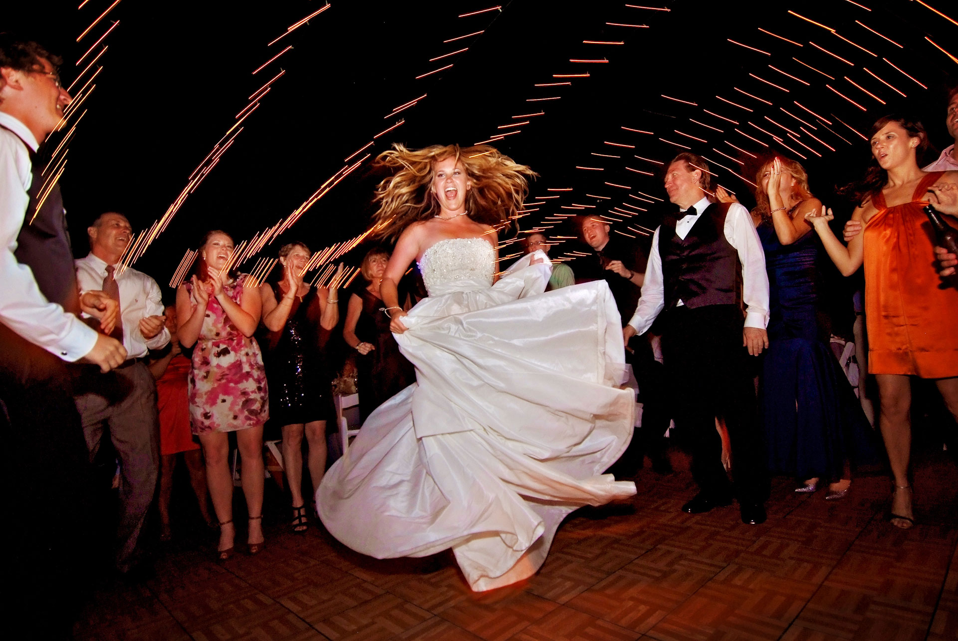 bride twirling and dancing with guests surrounding her at crosley mansion reception